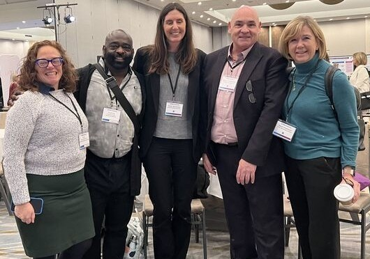 Amy Hondronicols, Courtney Bean, Emily Stevenson, Honourable George Smitherman and OPA's CEO Sarah Hutchison at the Association of Family Health Teams of Ontario conference on October 23, 2025.